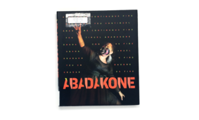 Book cover with a dancing Indigenous woman with a painted face.