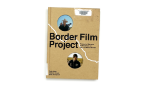 Book cover with holes cut out, showing photographs from book interior