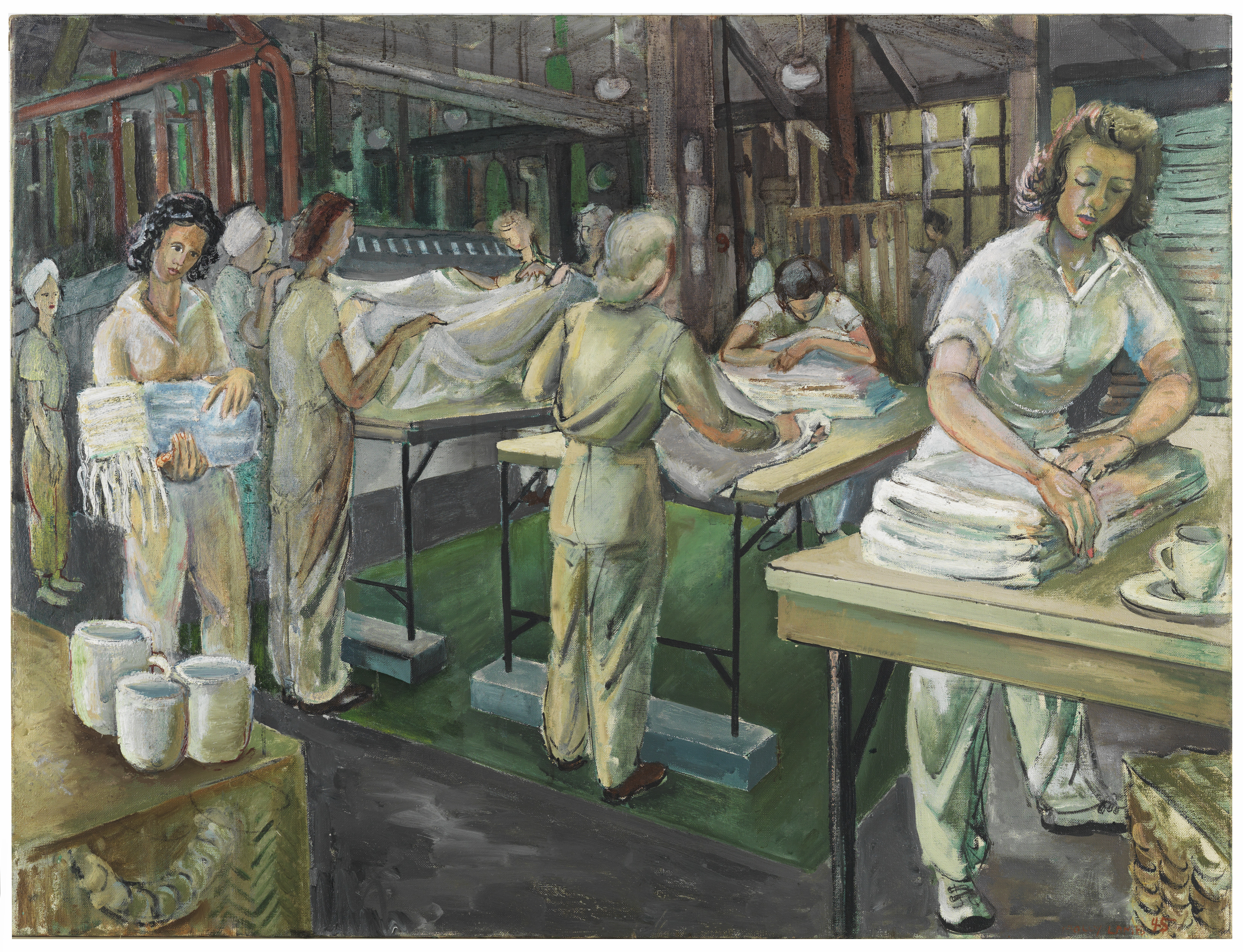 Women working in an industrial laundry, folding and handling large white sheets in a busy workshop.