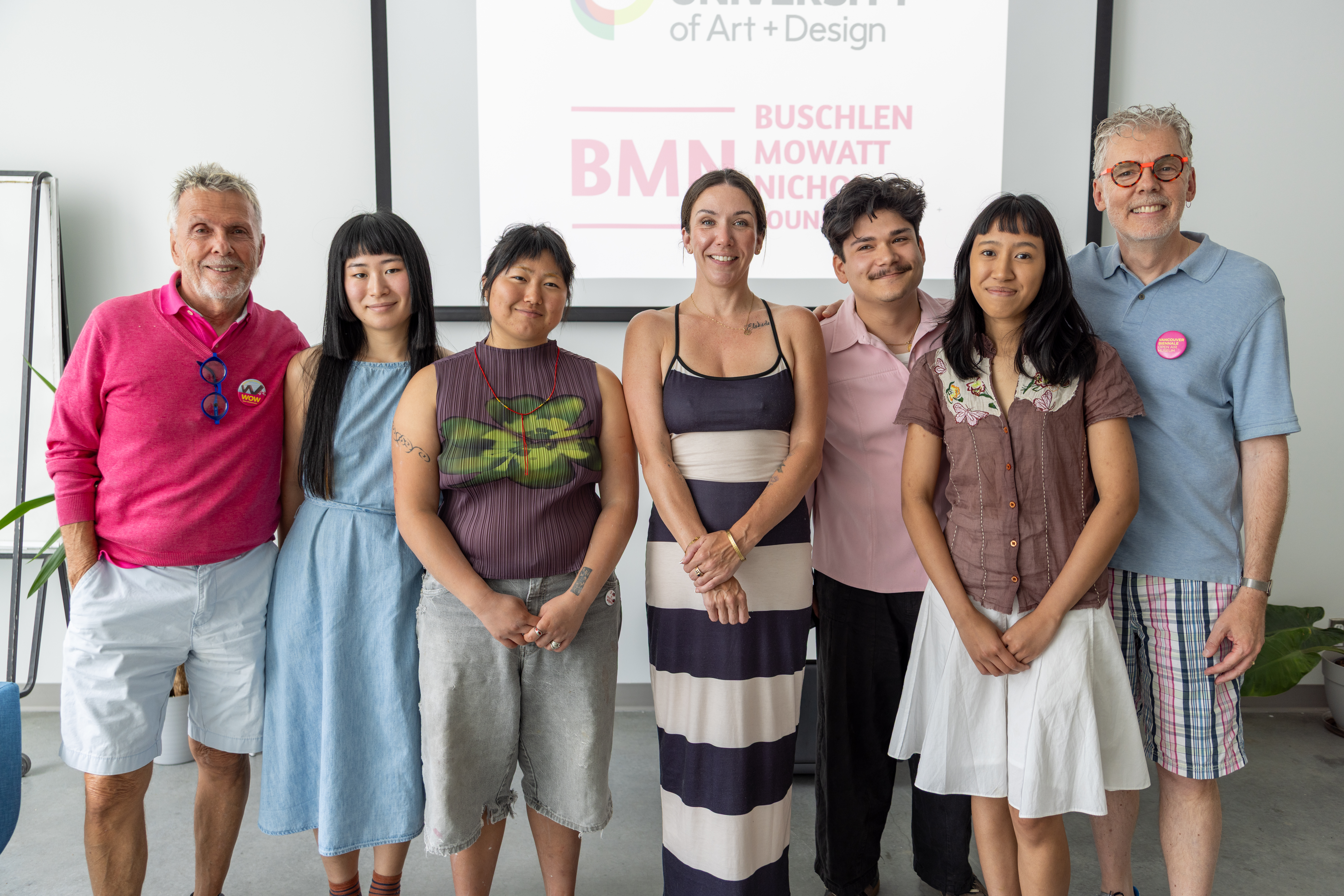 A group of 7 people standing together for a photo
