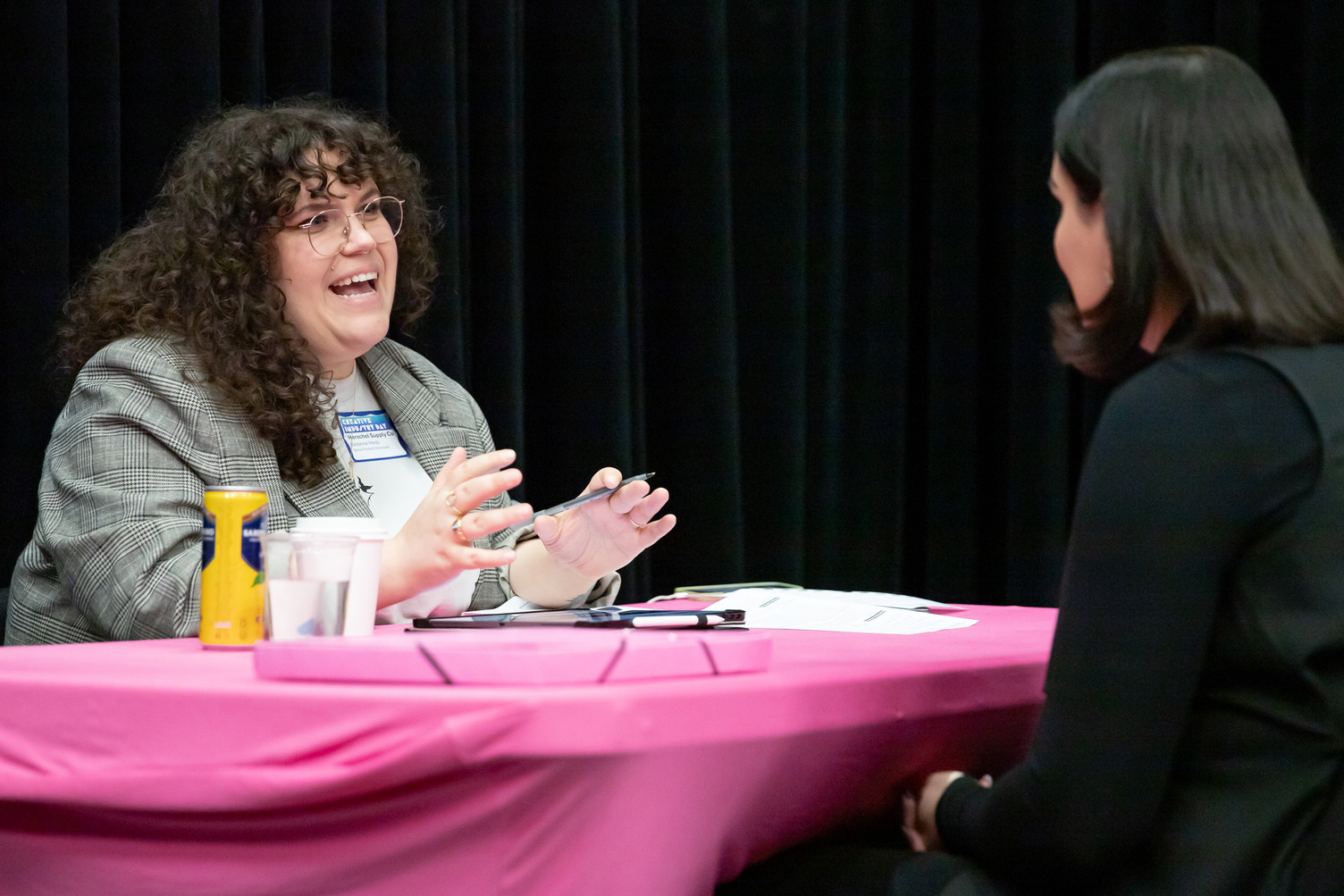 An industry lead using her hands in a chat with a student
