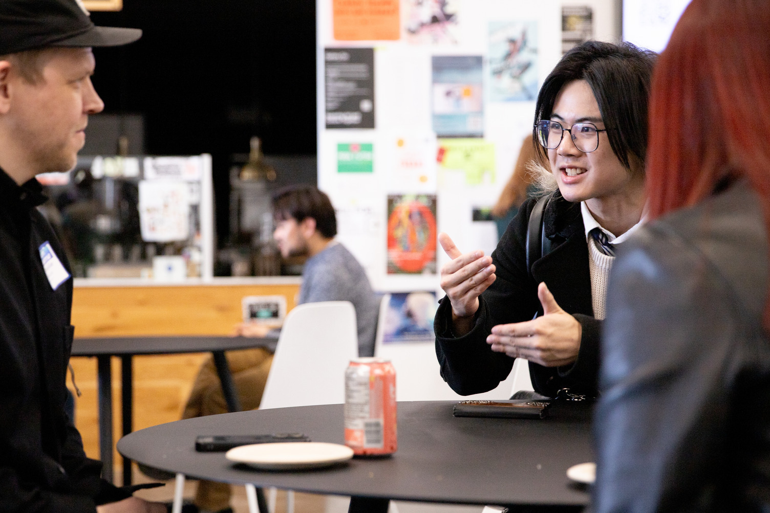 Students chat at a table at a mixer