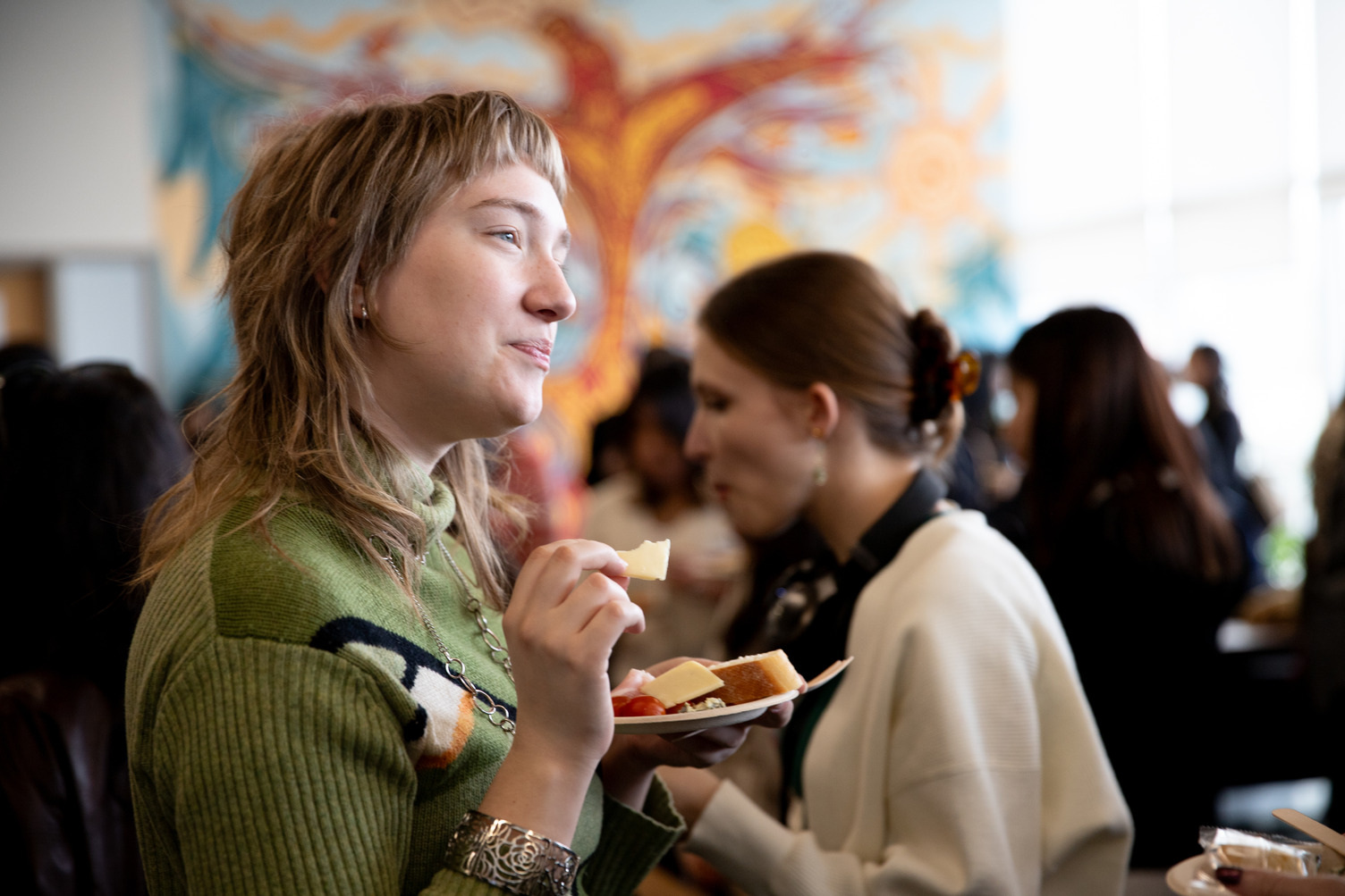A student with a plate in their hand at a mixer