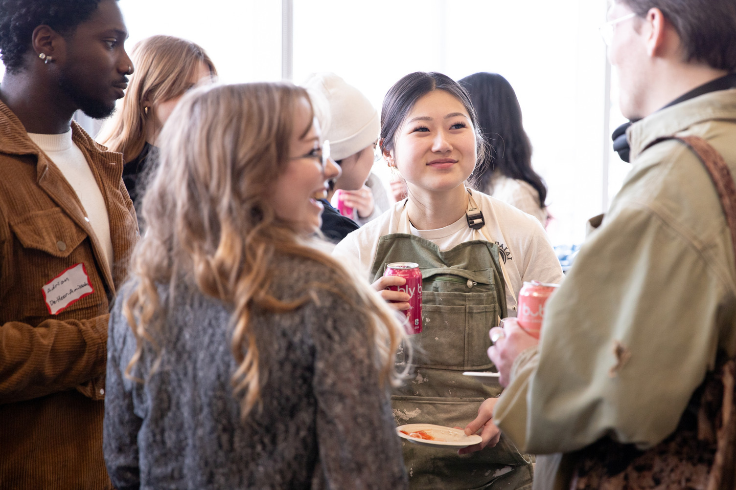 Four students chat at a mixer