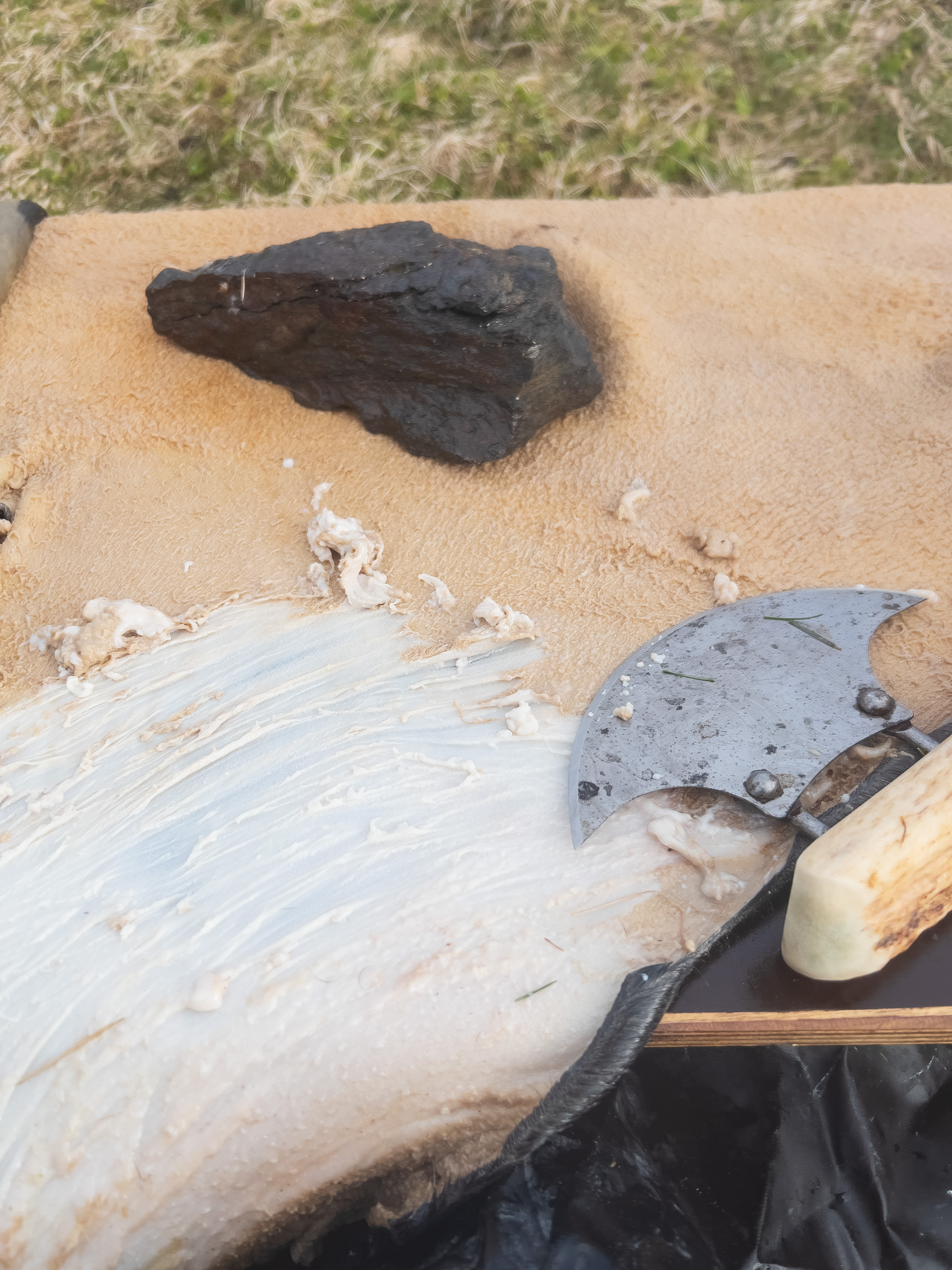 A tan hide with an ulu resting on top of it