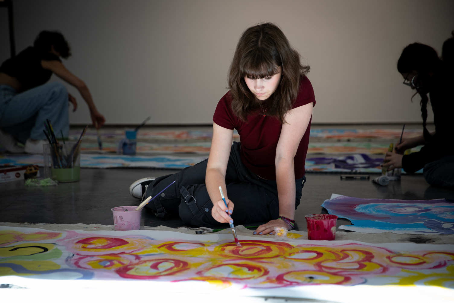 student on the ground painting
