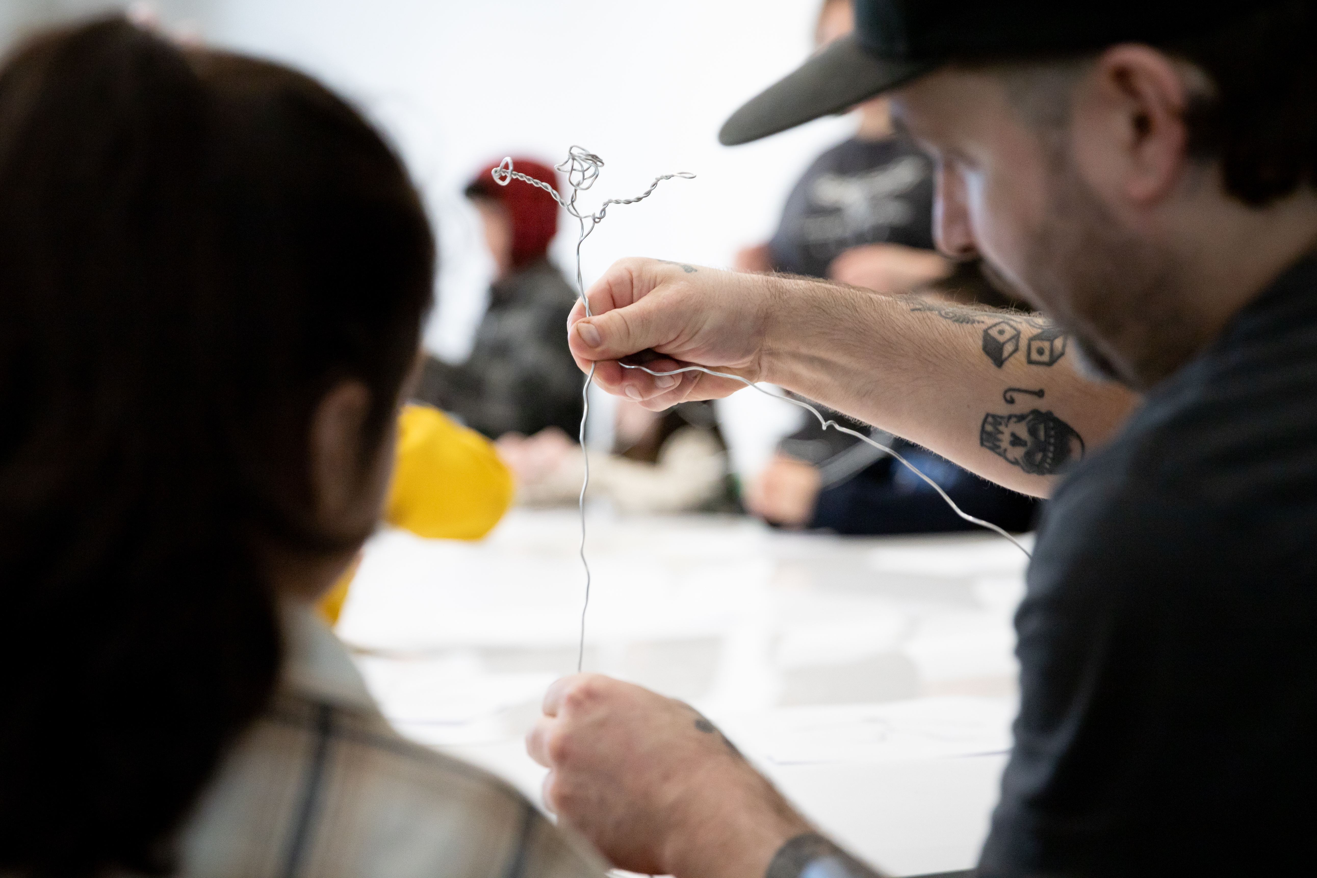 Animator Danny Guay right shows a student how to ply the wire