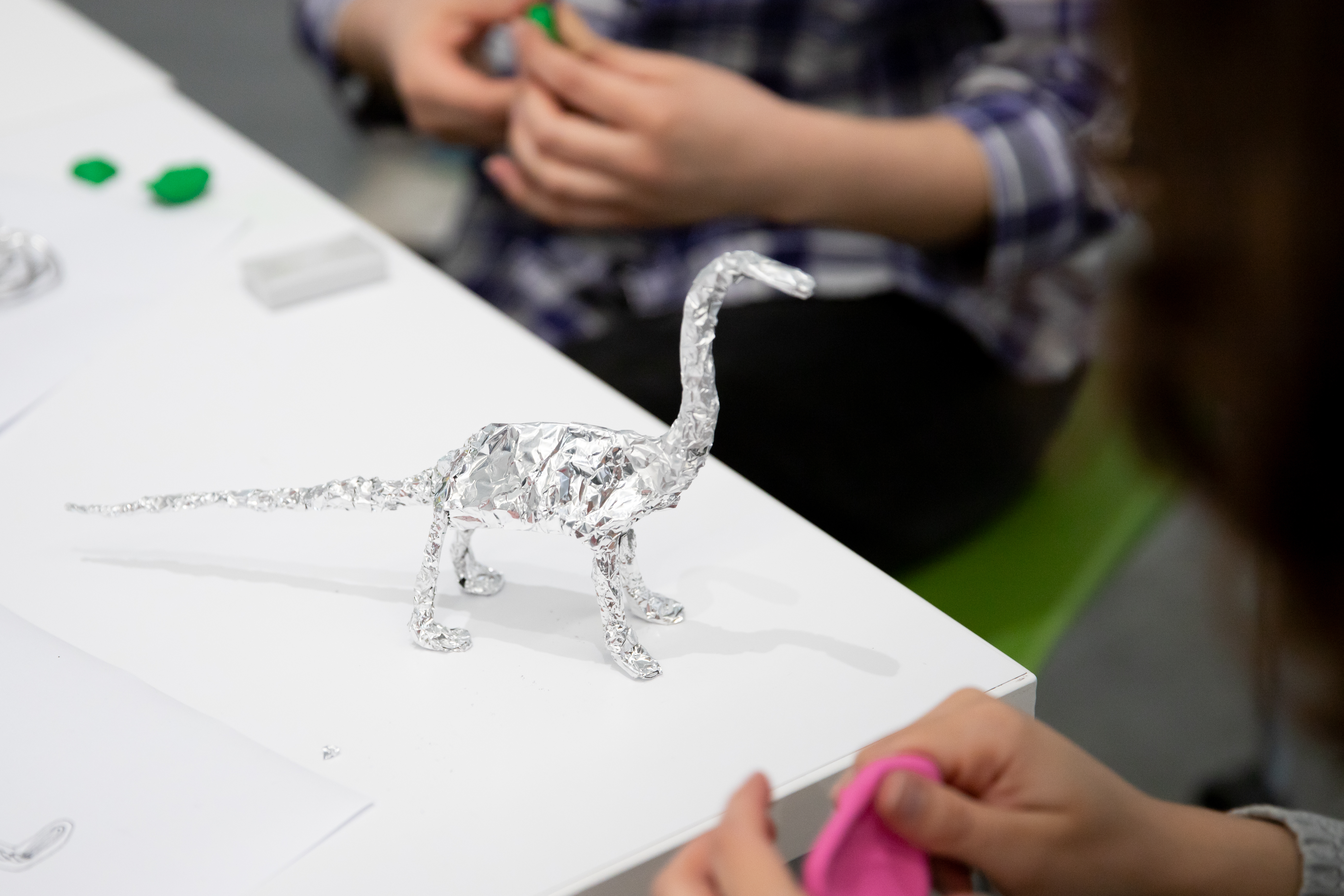 A foil dinosaur on a table