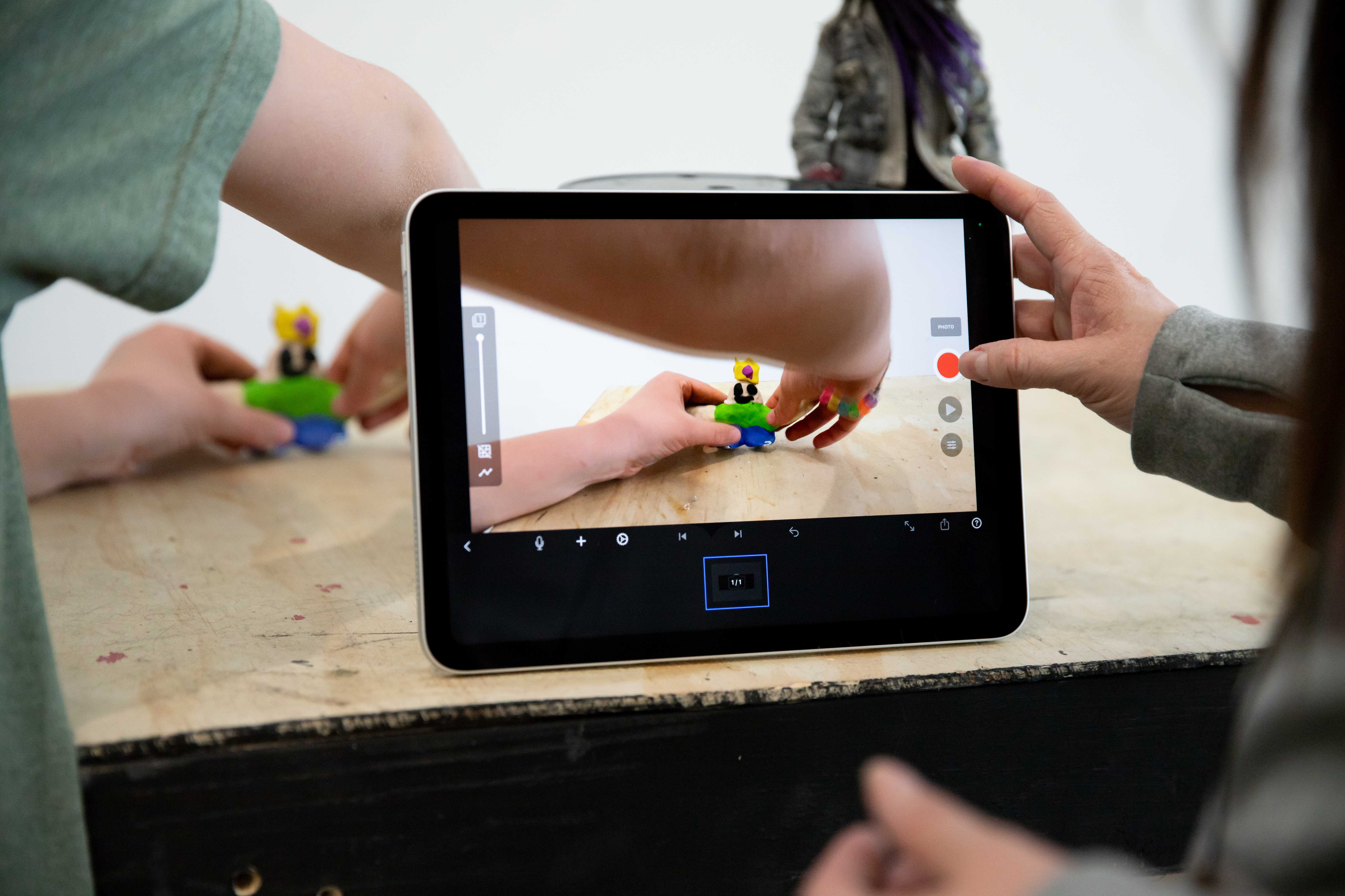 An iPad screen that shows a student's moving their figures into the frame