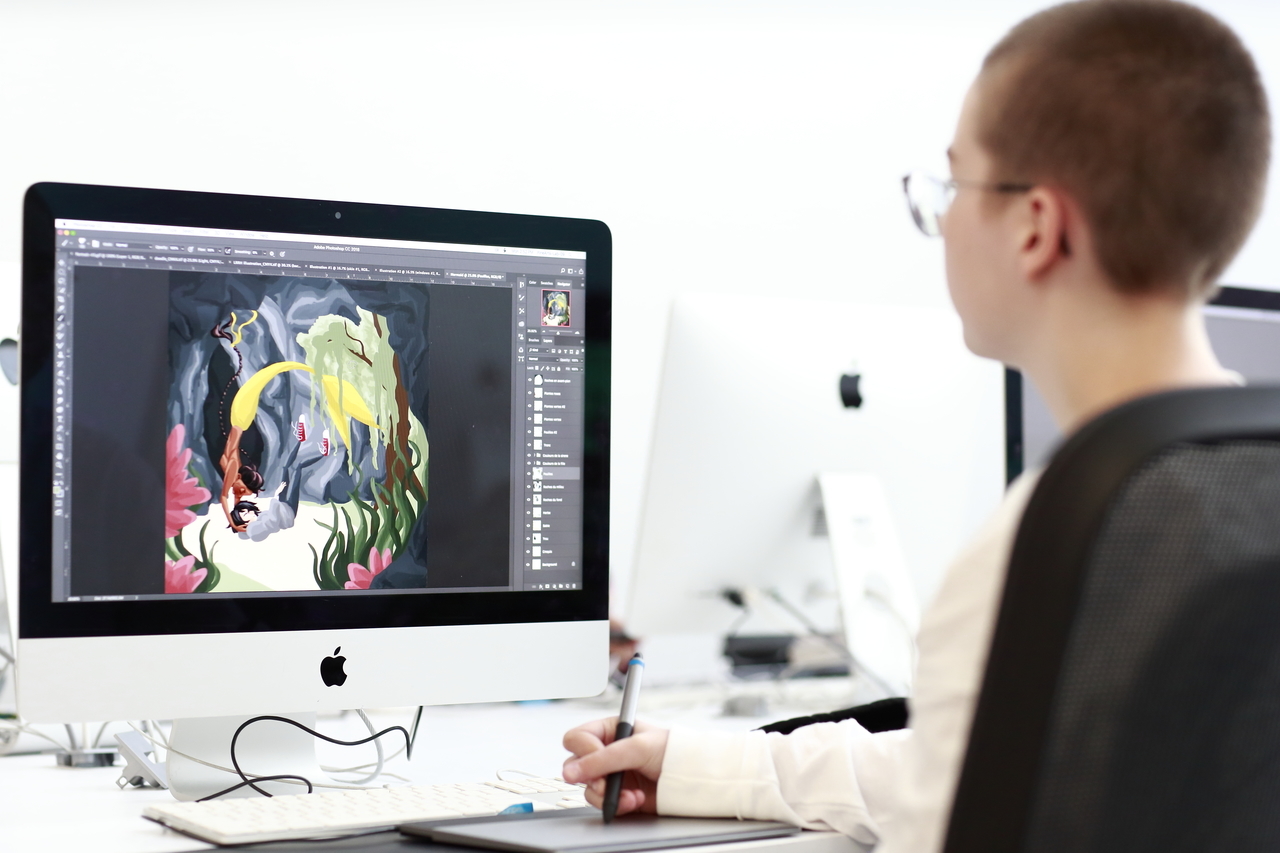 student in front of computer with design file open