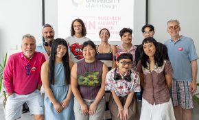 A group of people in two rows pose together