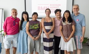 A group of 7 people standing together for a photo