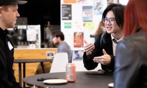Students chat at a table at a mixer