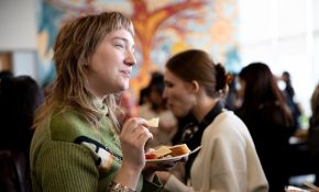 A student with a plate in their hand at a mixer