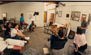 A group of students and a faculty member in a classroom on campus on Granville Island.