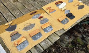A tan spread with many different types of ulu knives