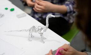 A foil dinosaur on a table