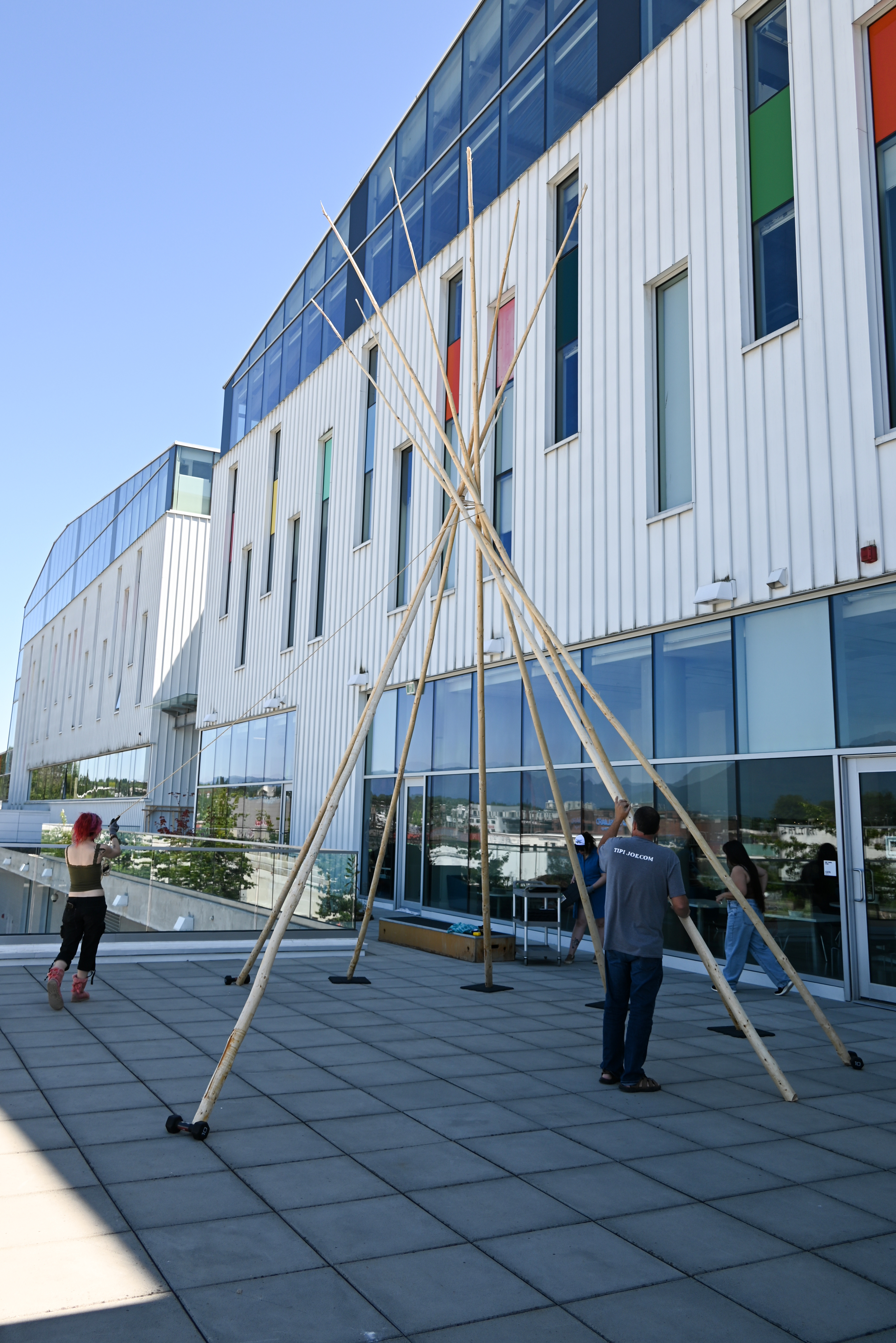 The tipi raising begins on the north patio at ECU. (Photo by Sydney Pascal / courtesy the AGP)