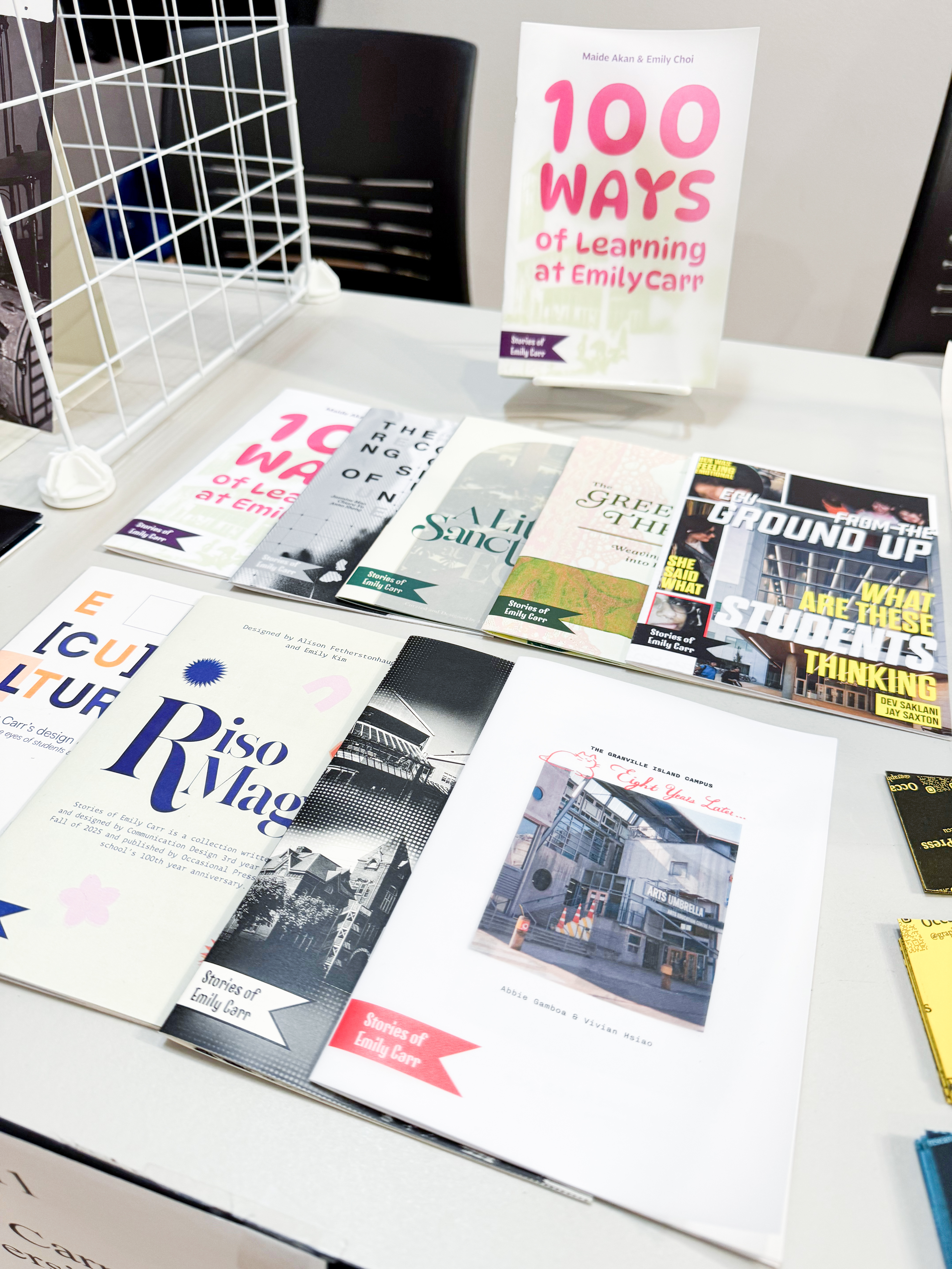 Colourful printed booklets are displayed on a table.