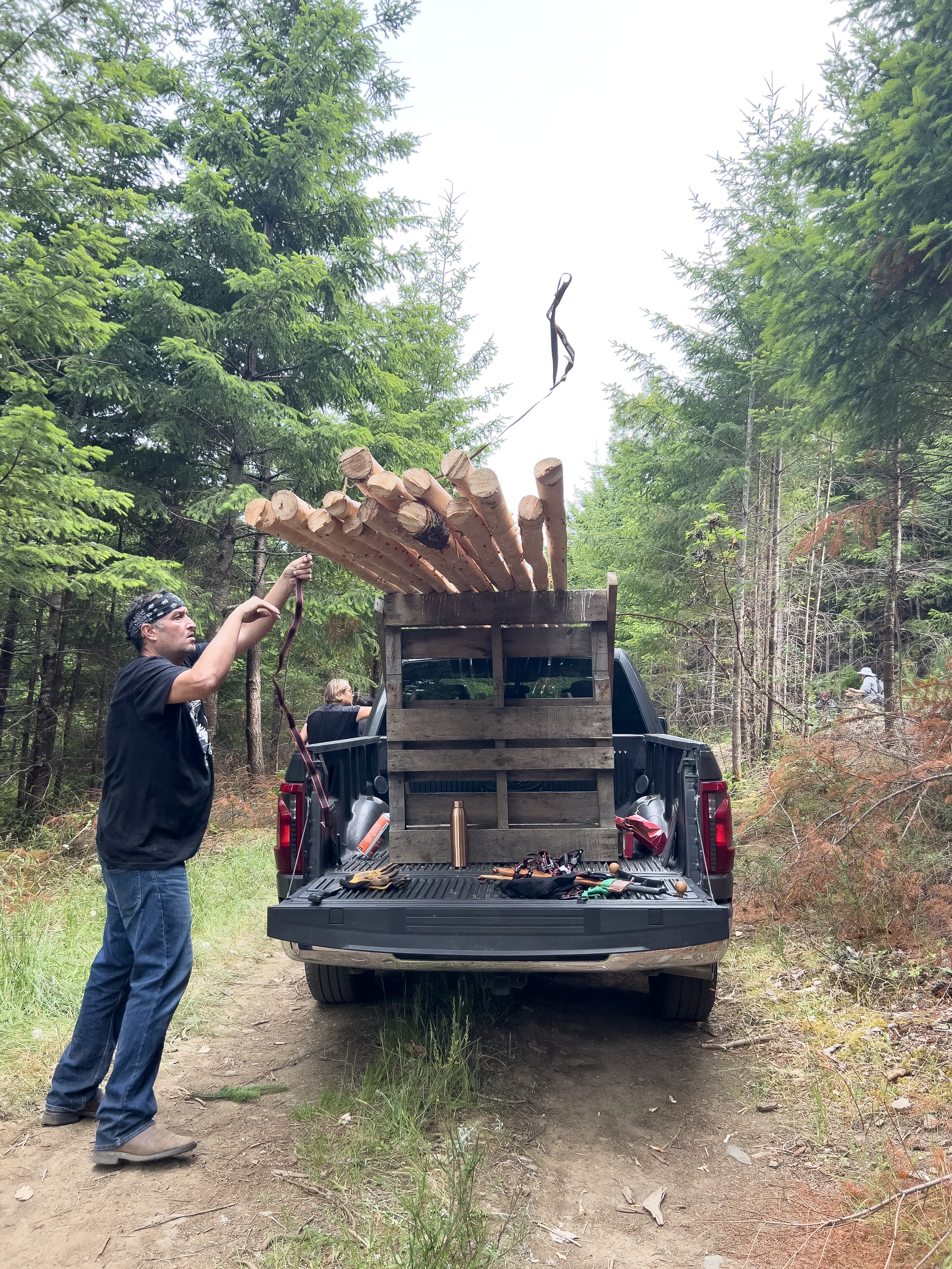 (From L): Tipi Joe loads the truck to bring the poles back to Vancouver. (Photo by Sydney Pascal / courtesy AGP)