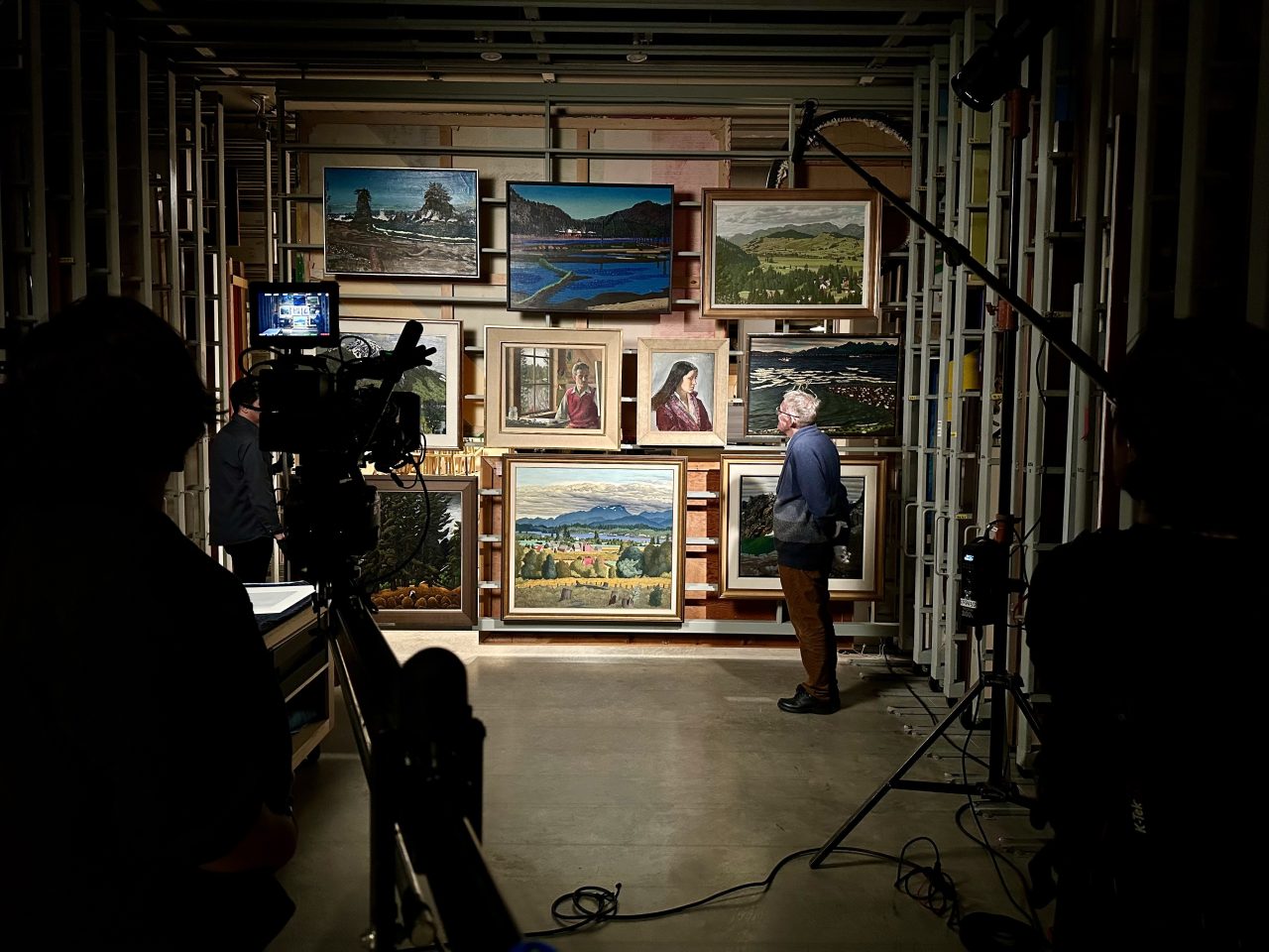 EJH Ian Thom looks at paintings by EJ Hughes in the vault at the Vancouver Art Gallery Photo by Kevin Eastwood